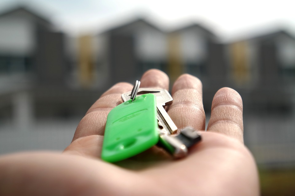 Hand with house keys, property keys
