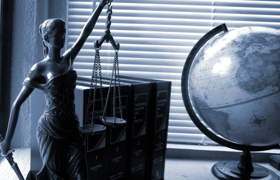 Desk with an earth globe, Legal statue with a balance and books